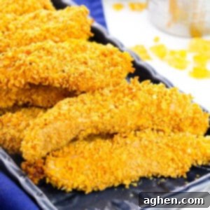 Baked Cornflake Chicken Tenders on a black plate, ready to be served.