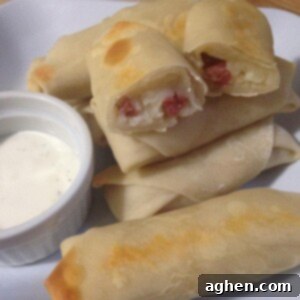 Cheesy Loaded Mashed Potato Rolls 2 Close up of a golden-brown loaded mashed potato egg roll