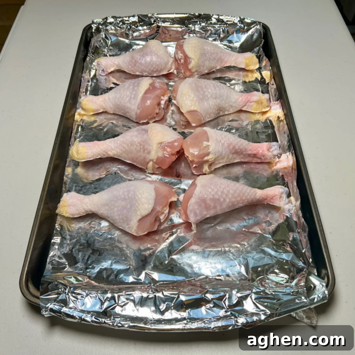 Ultimate Smoked Chicken Legs 5 raw chicken drumsticks on tray, ready for seasoning