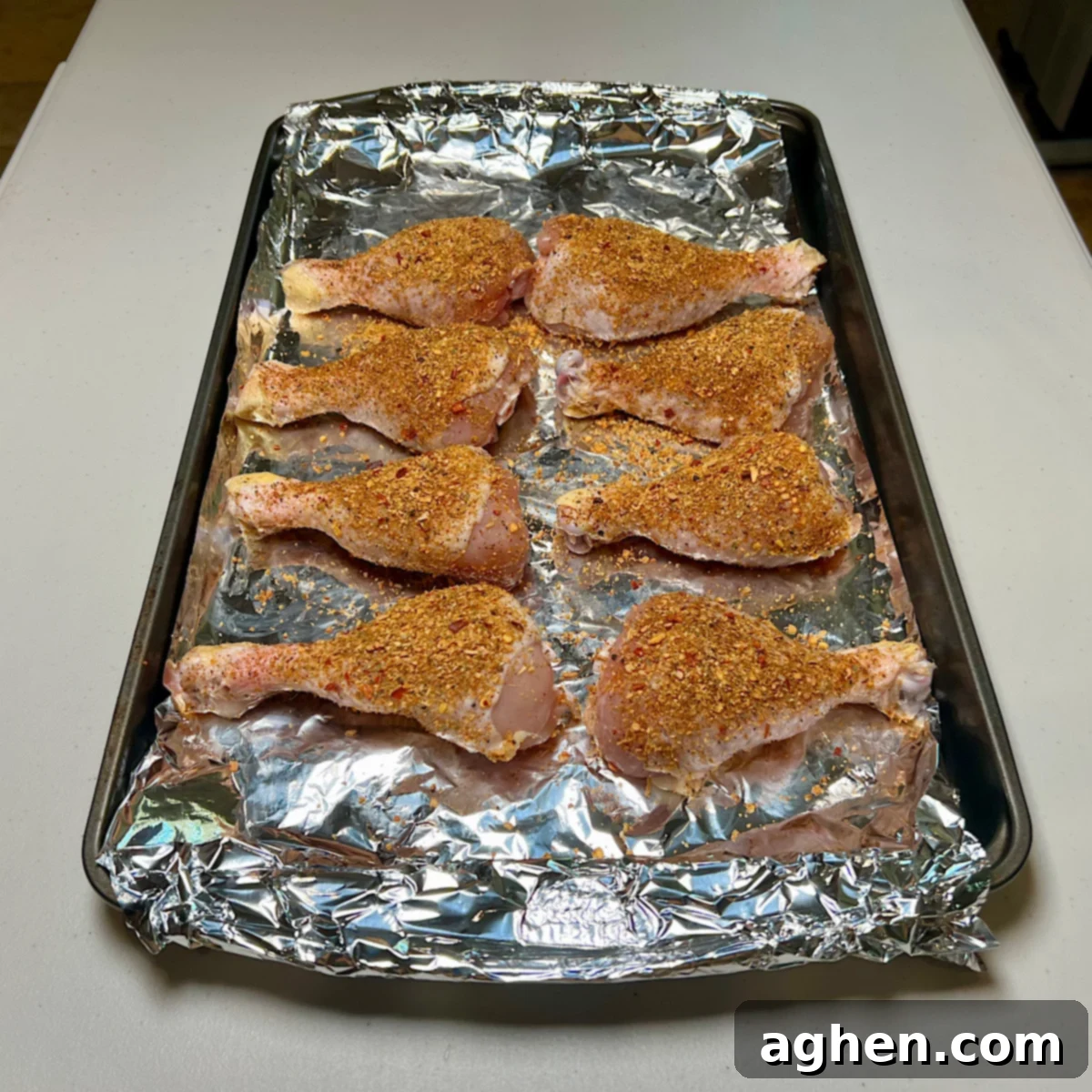 Ultimate Smoked Chicken Legs 6 rubbed chicken drumsticks on tray, fully seasoned