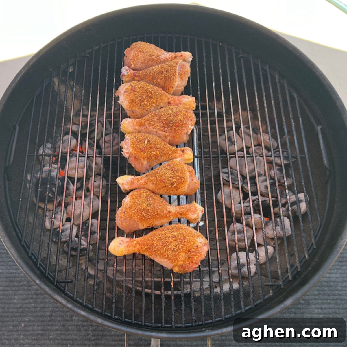 Ultimate Smoked Chicken Legs 7 raw chicken drumsticks on grill grate, ready for smoking