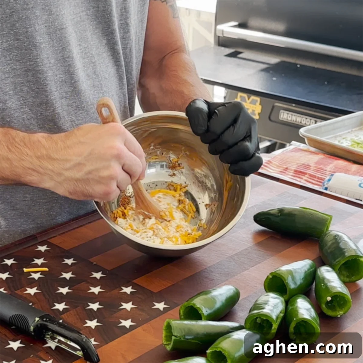 Mixing cream cheese and shredded cheddar cheese with seasoning in a bowl.