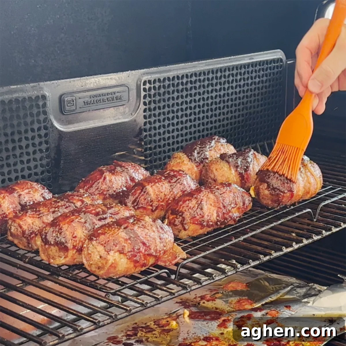 Finished Bacon-Wrapped Armadillo Eggs with BBQ sauce glaze, perfectly crisped.