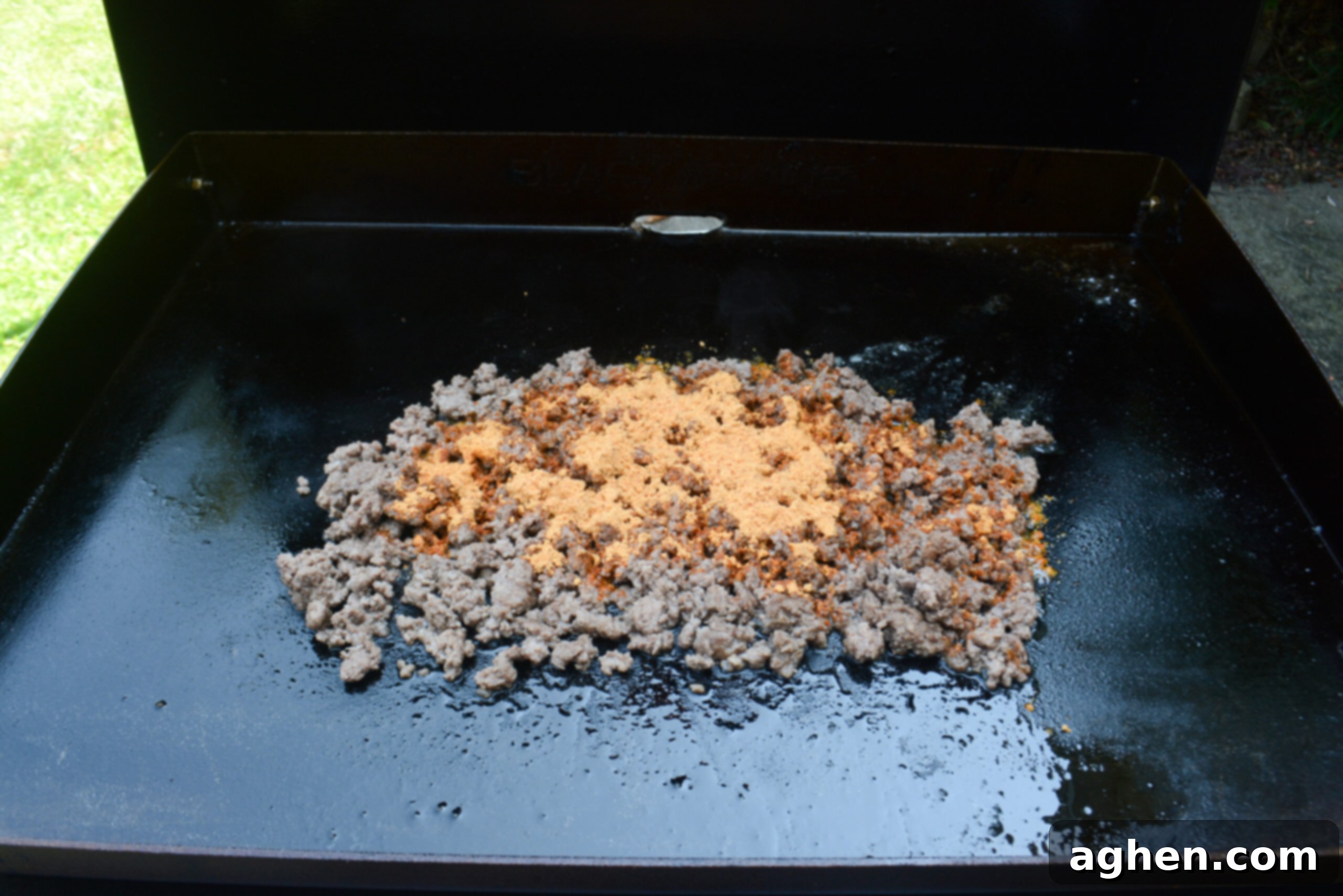 The Backyard's Best: Blackstone Tacos 5 A photo of the browned ground beef on the Blackstone sprinkled with taco seasoning.