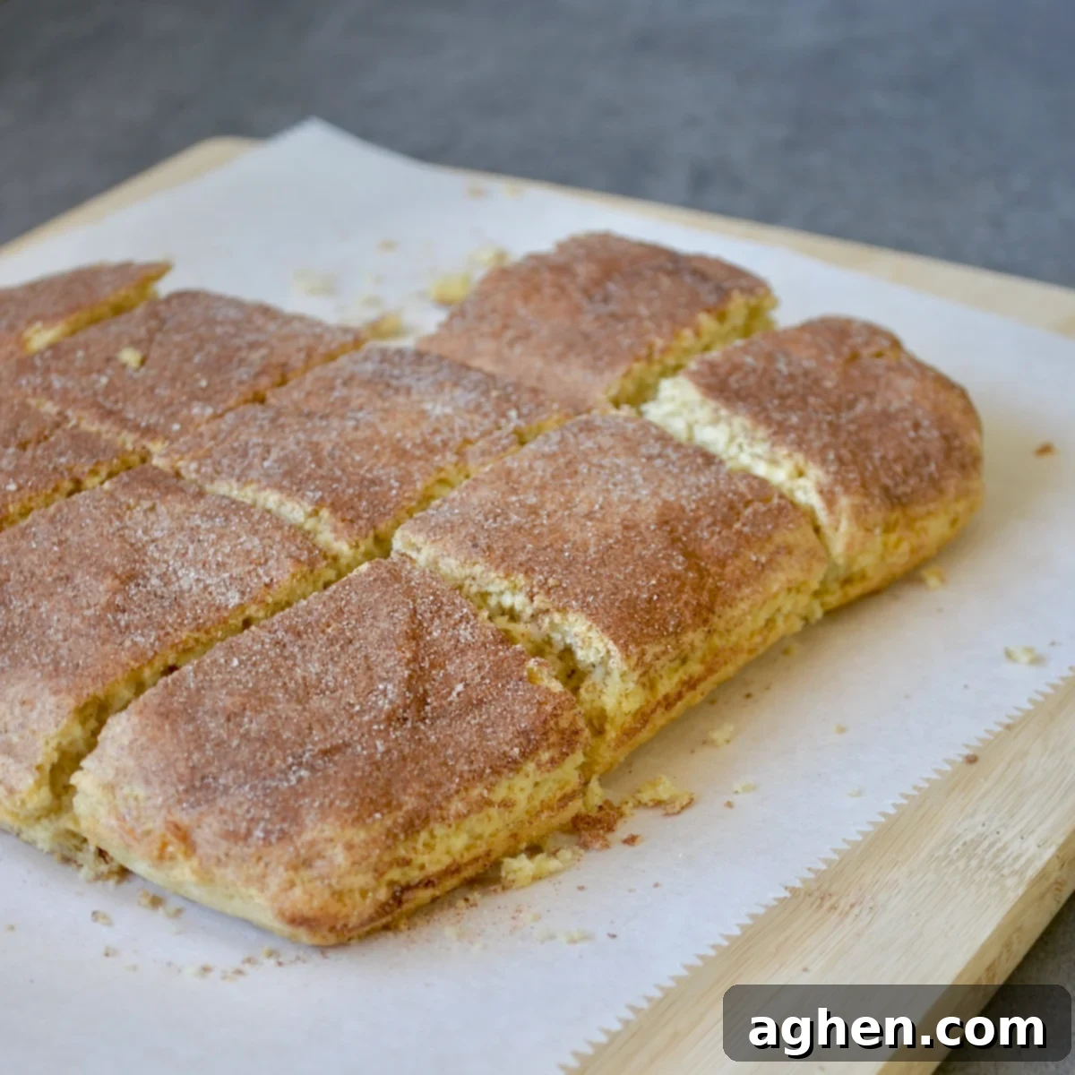 Family-Favorite Weight Watchers Snickerdoodle Bars 7 Perfectly sliced Weight Watchers Snickerdoodle bars arranged neatly on a wooden cutting board.