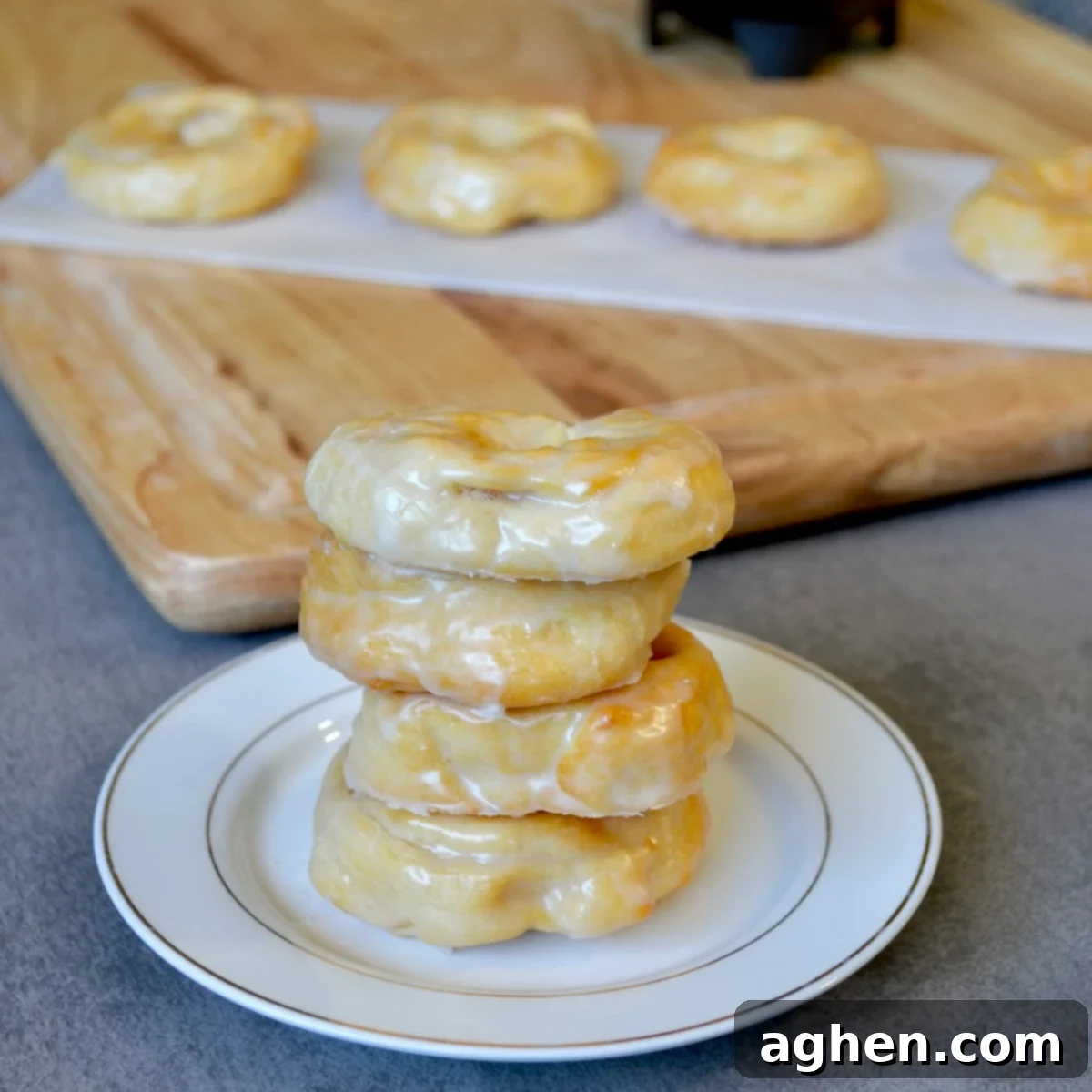 Freshly glazed Weight Watchers Crescent Cronuts arranged on a white plate, ready to be served for breakfast.
