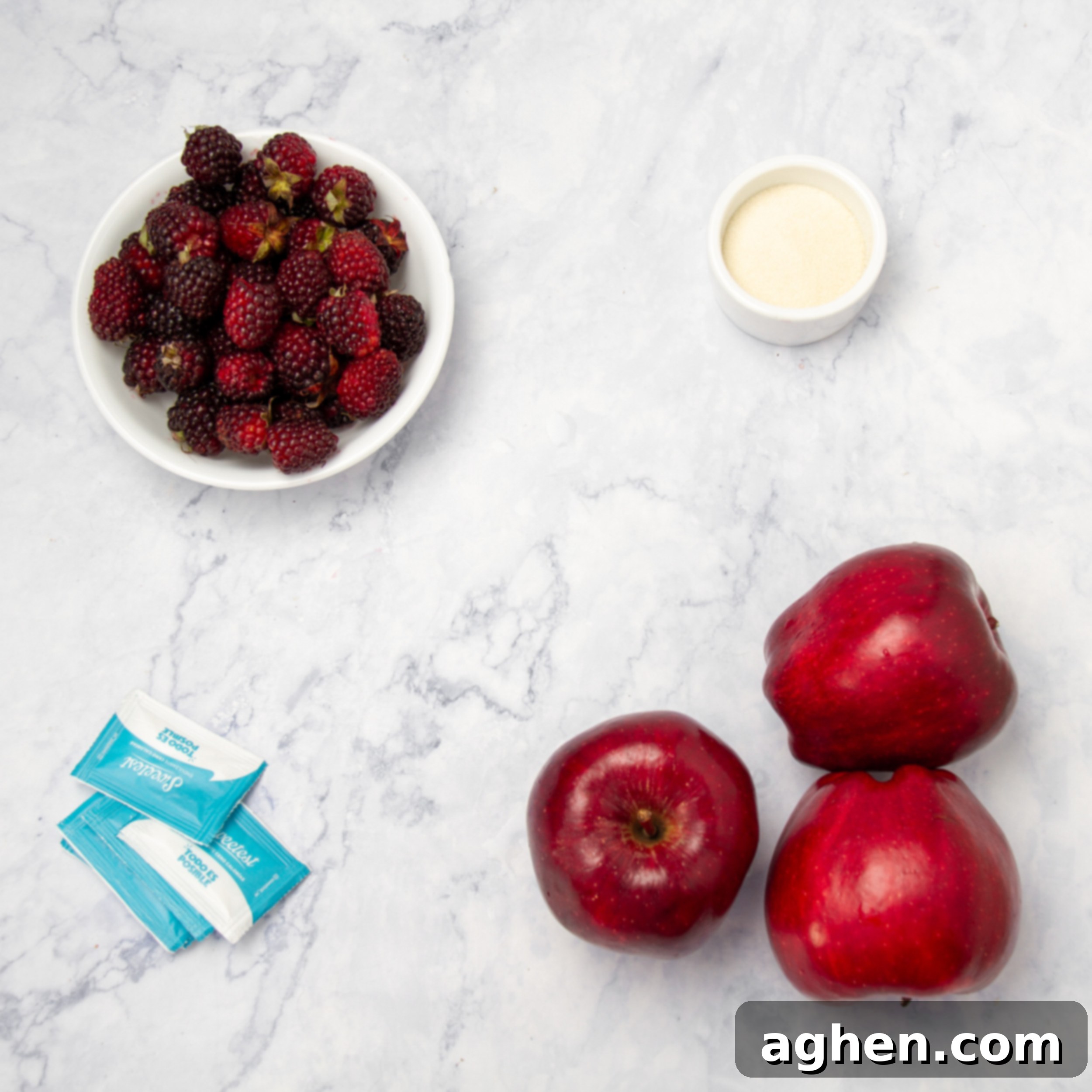 Apples, blackberries, stevia packets, and lemon juice in separate dishes, ready for jam preparation.