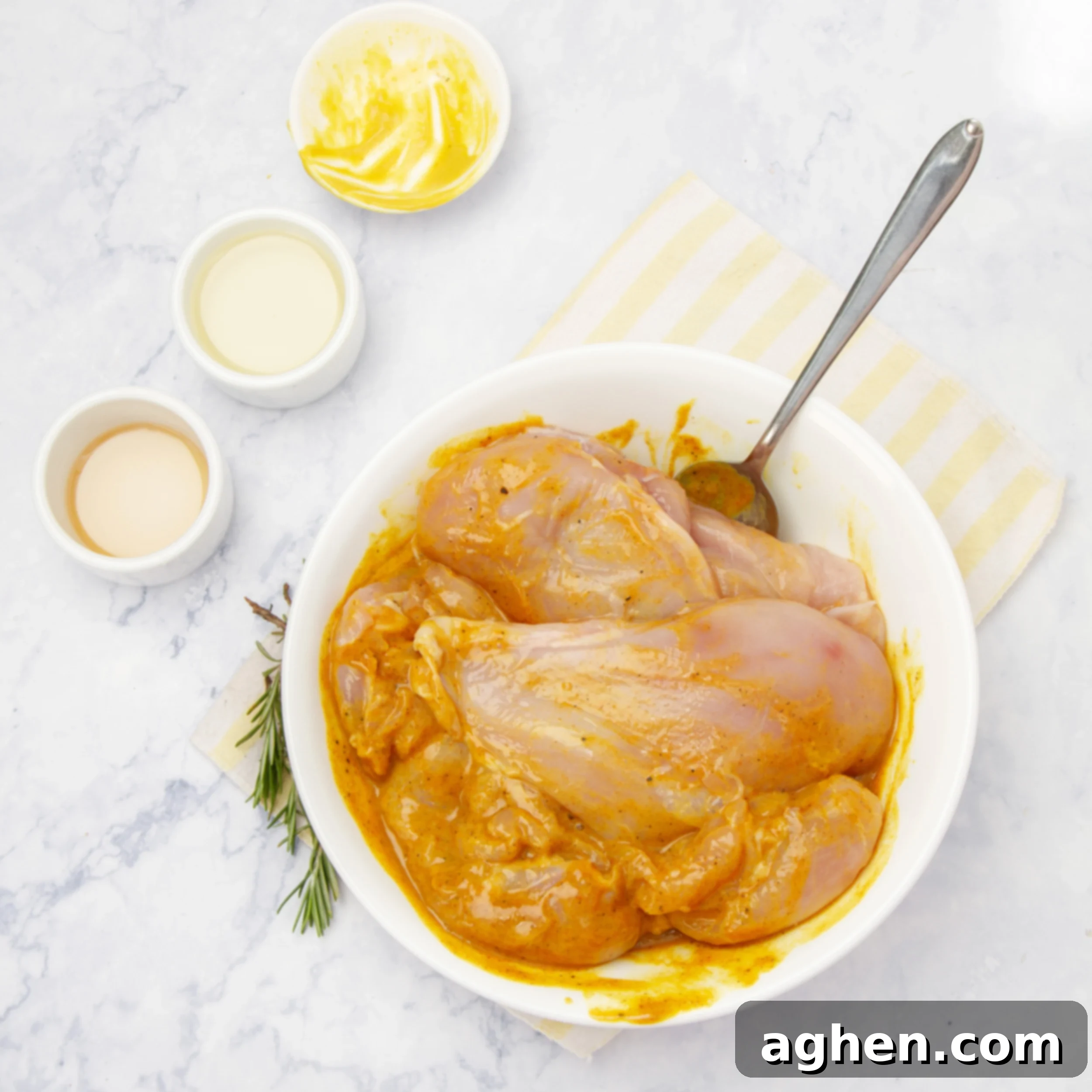 Chicken breasts marinating in the honey mustard sauce in a bowl.