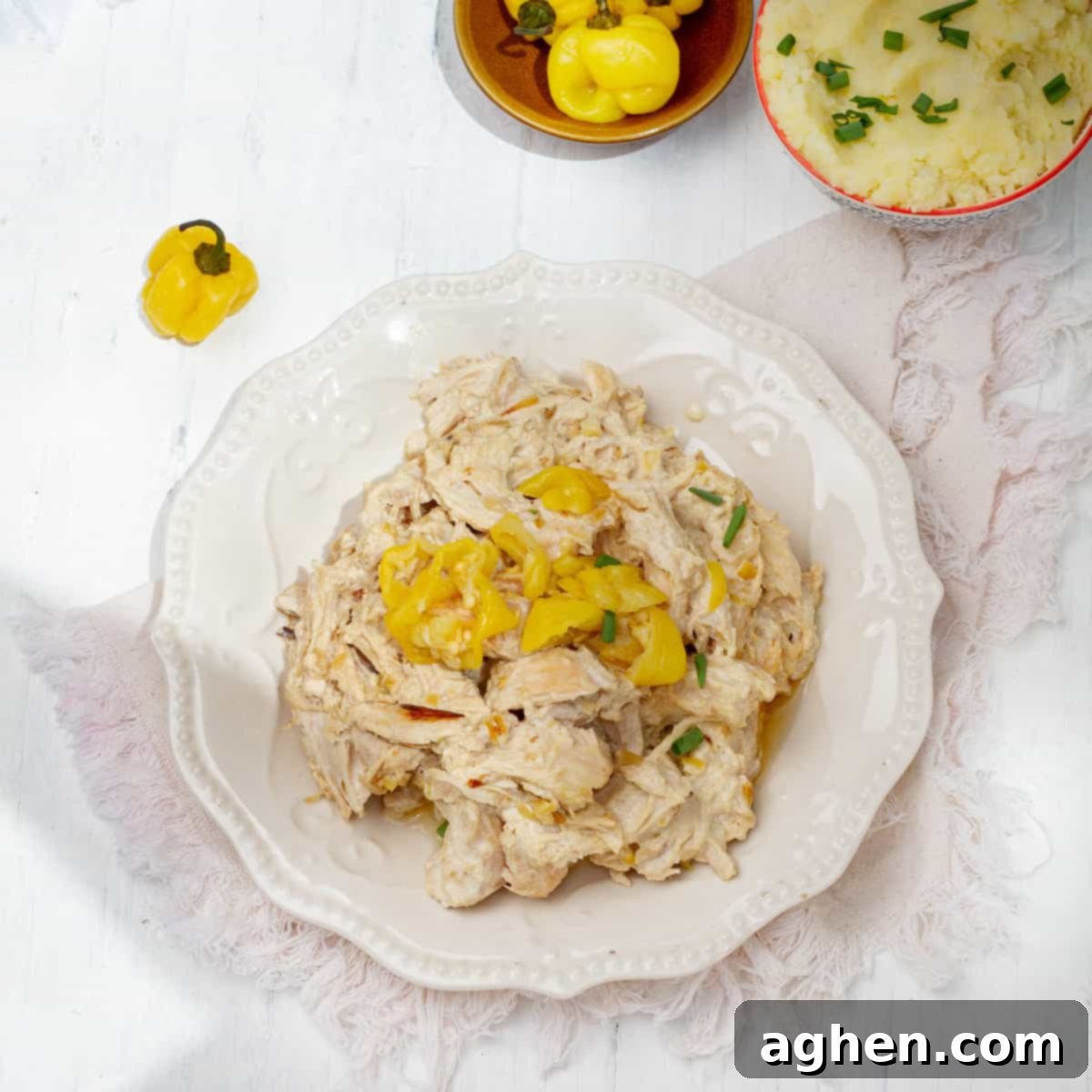 Shredded Mississippi Chicken garnished with yellow pepper.