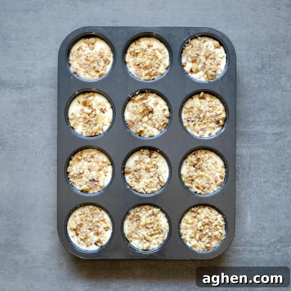 Lightened Maple Walnut Muffins 4 Unbaked muffins with nuts on top