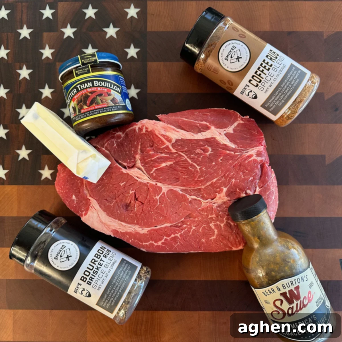 A selection of high-quality ingredients, including a chuck roast, various rubs, and sauces, laid out for preparation.