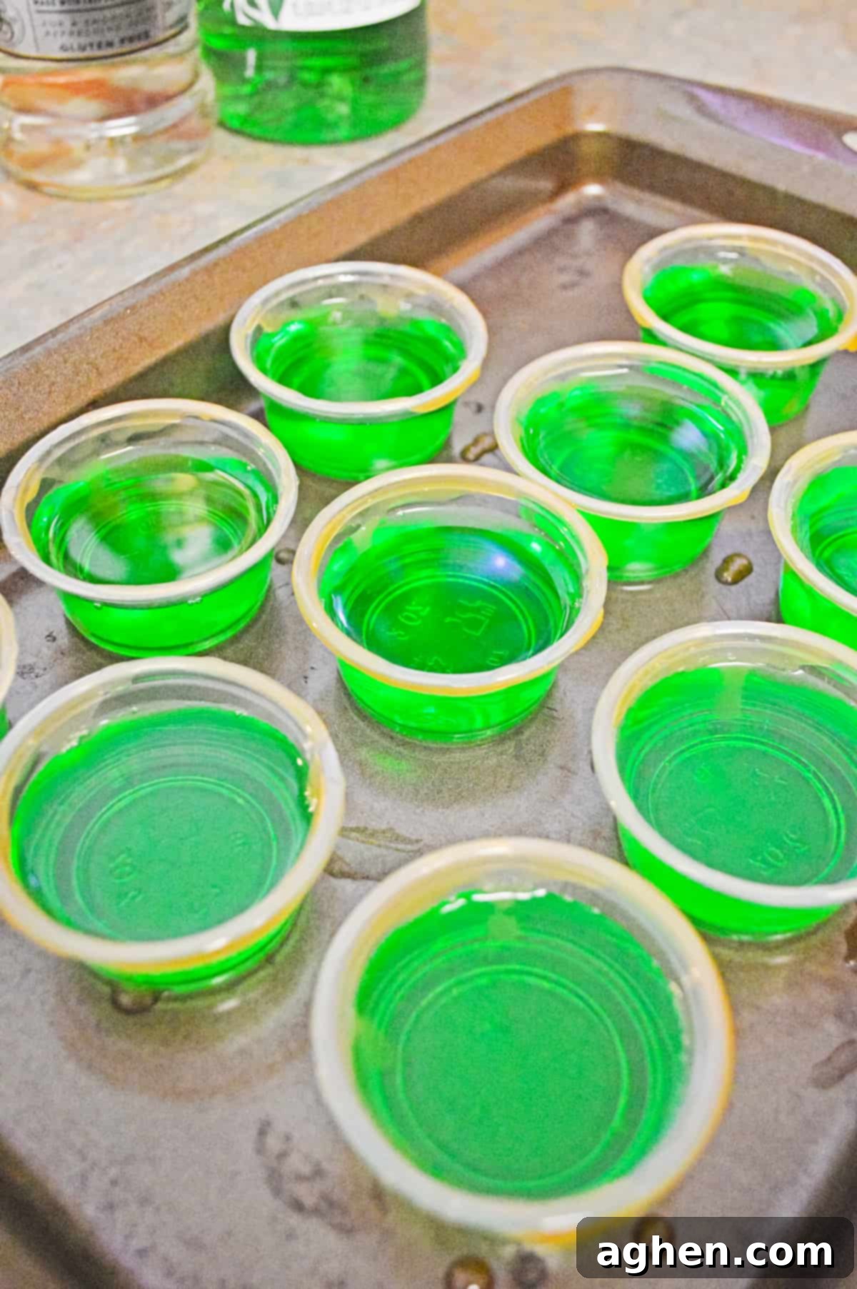 green apple jello shots on baking sheet