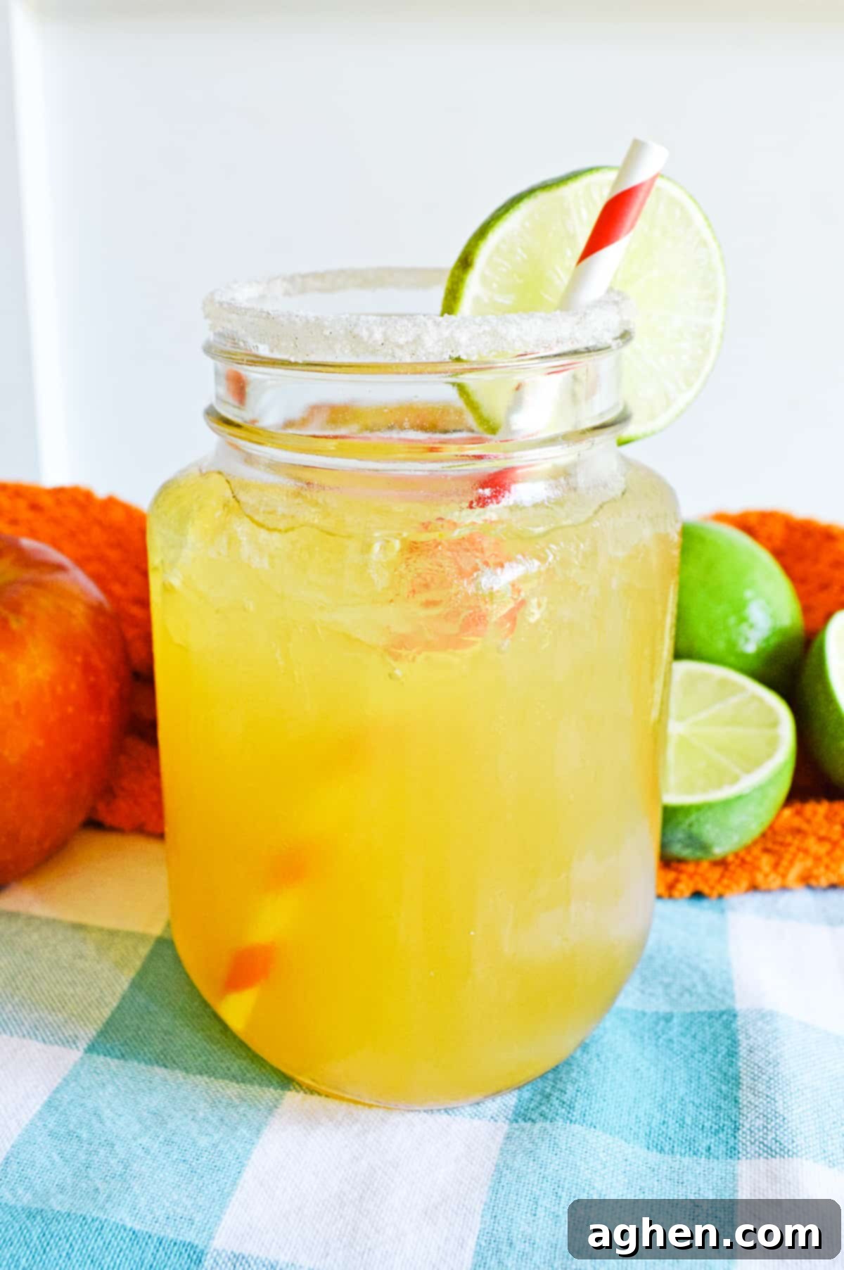 Apple Cider Margarita cocktail served in rimmed glass with slice of lime