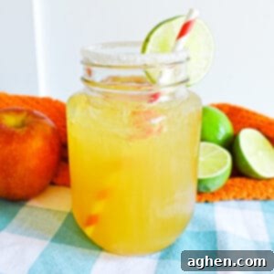 Apple Cider Margarita in mason jar with sugared rim and lime garnish
