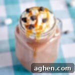 Boozy hot chocolate with caramel vodka, whipped cream, caramel sauce, and chocolate chips.