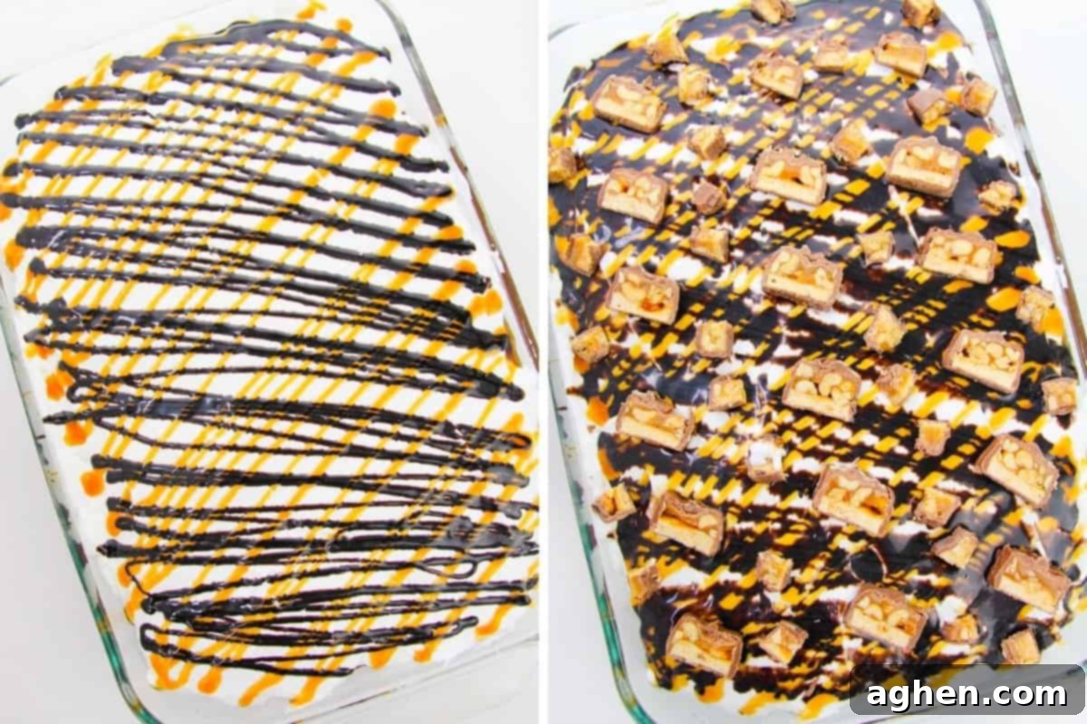 Finished Snickers poke cake in a 9x13 pan with Cool Whip, generous chunks of Snickers candy bars, and drizzles of chocolate and caramel sauce.