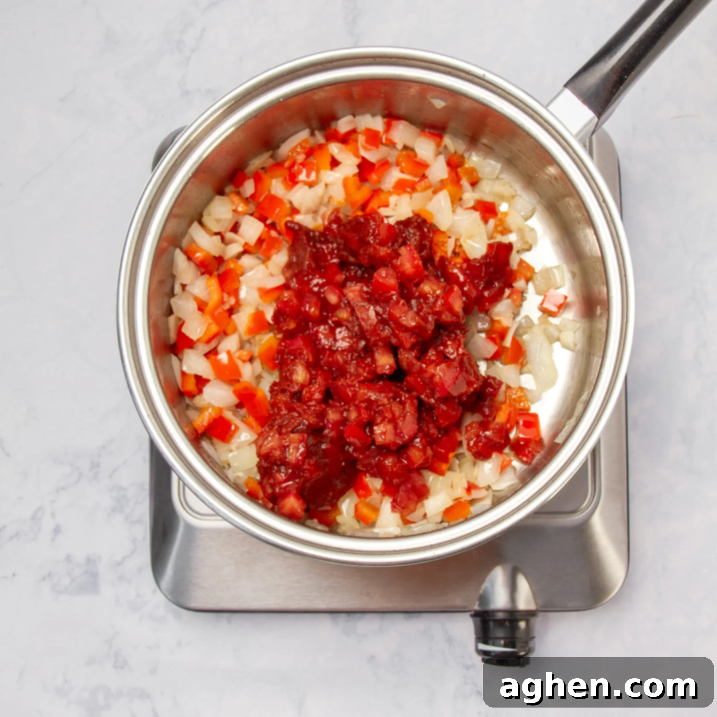 Your Go-To Weight Watchers Mexican Chicken Casserole 4 Finely chopped onions and diced red bell peppers sautéing in olive oil in a hot skillet, releasing fragrant aromas.