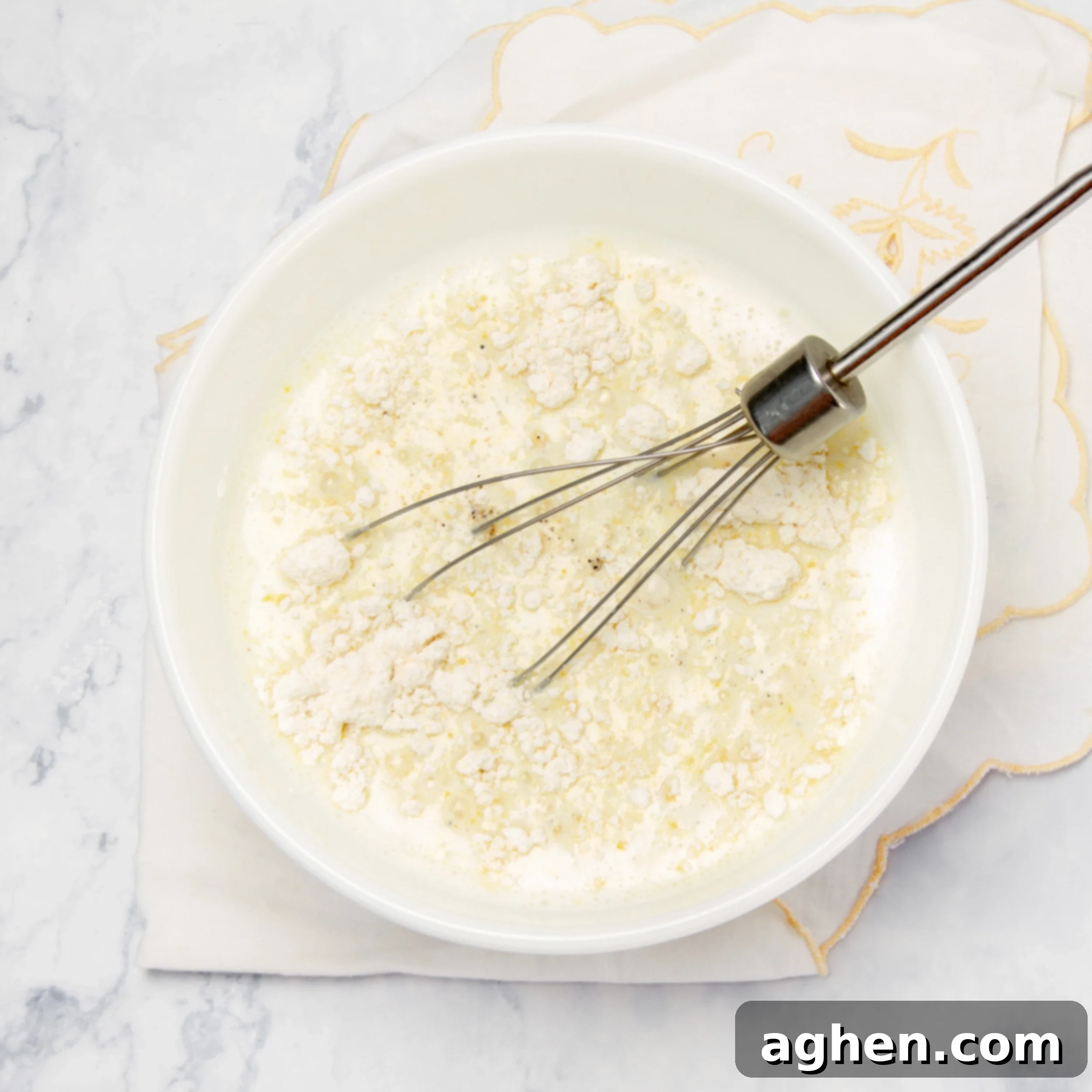 Your Go-To Weight Watchers Mexican Chicken Casserole 5 Cream of chicken soup mix being whisked into a bowl of skim milk, creating a smooth, creamy base for the casserole.
