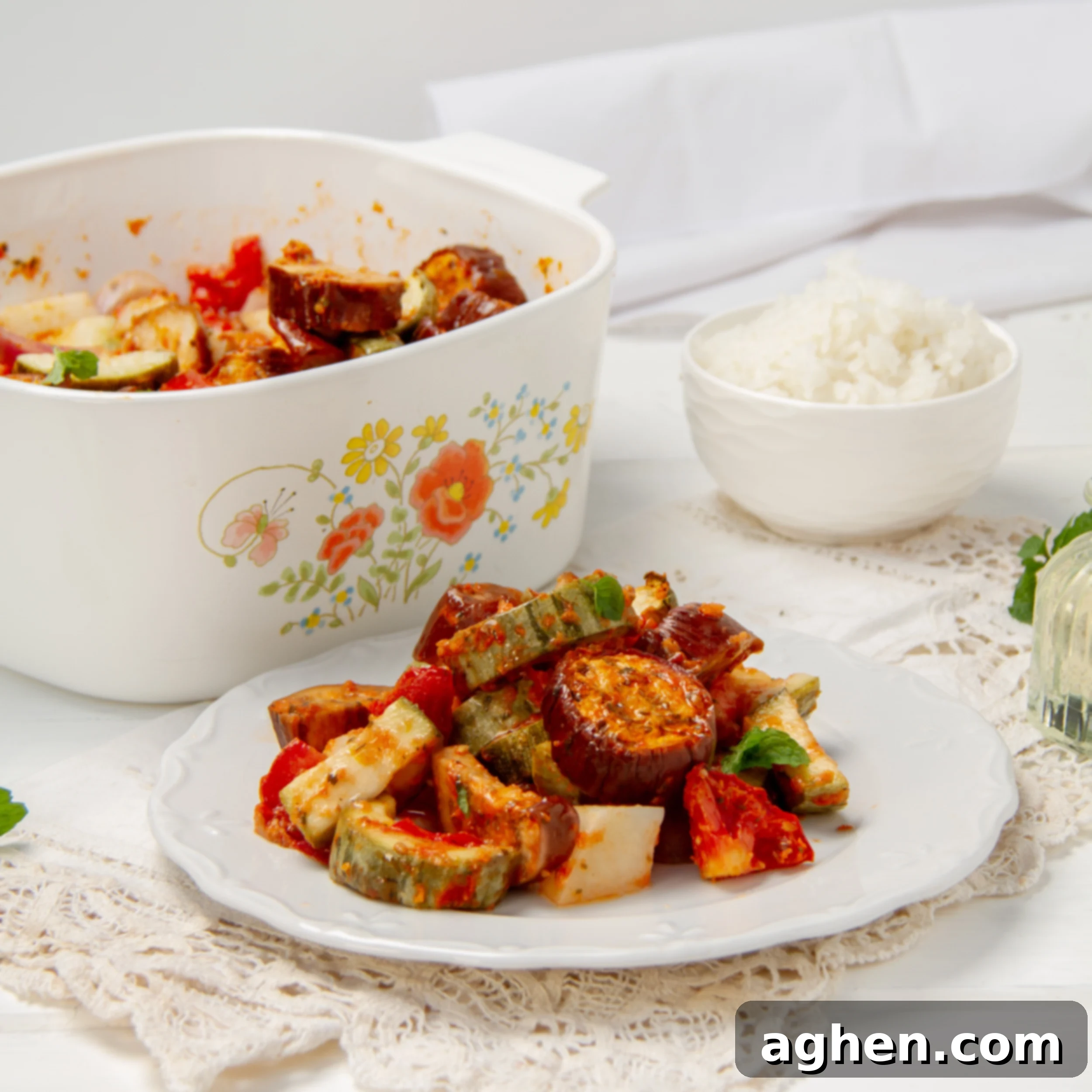 Greek Vegetable Casserole Your Weight Watchers Go-To 2 Greek Vegetable Casserole, known as Briam, served on a plate beside a baking dish.