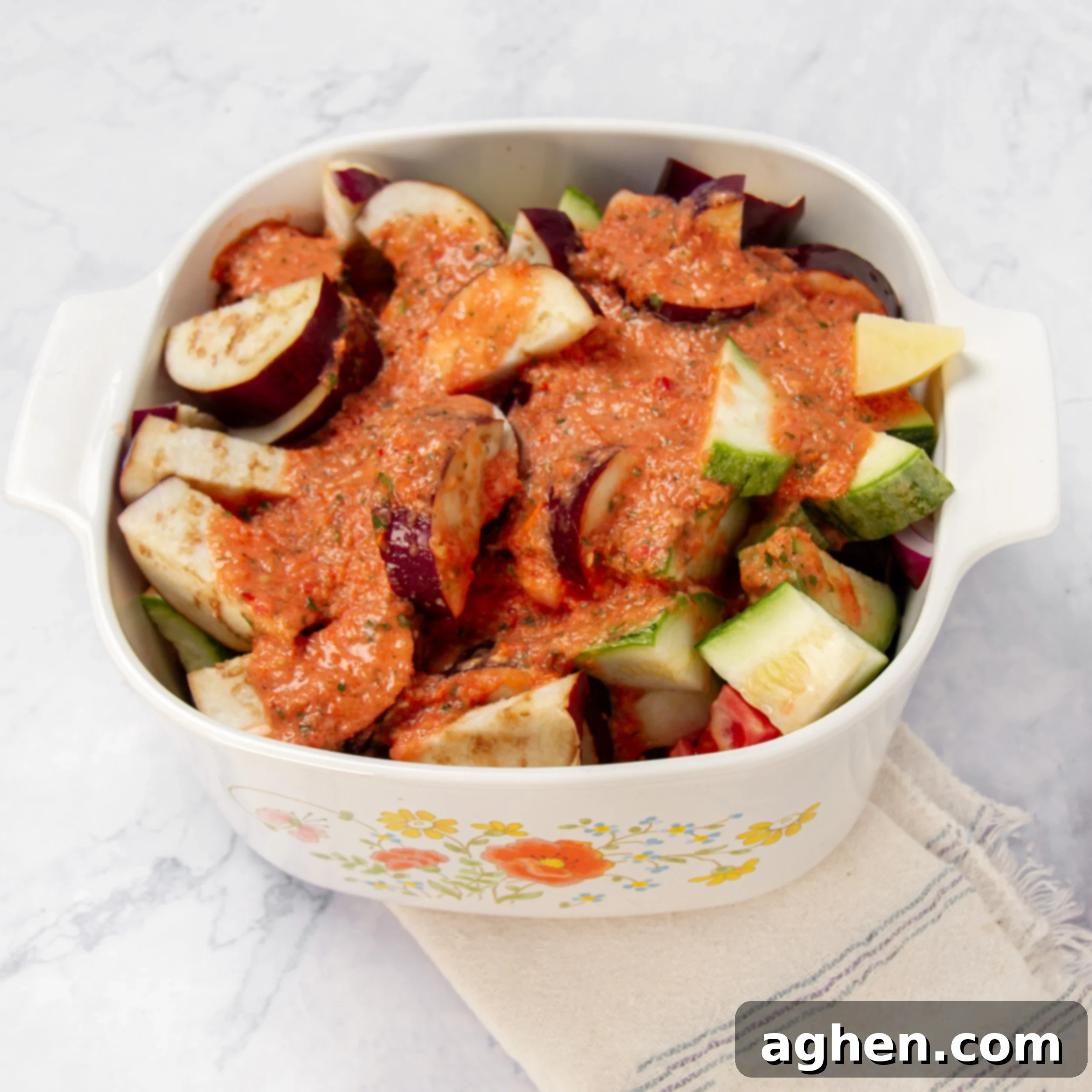 Greek Vegetable Casserole Your Weight Watchers Go-To 6 Chopped vegetables in a casserole dish with the blended sauce poured on top.