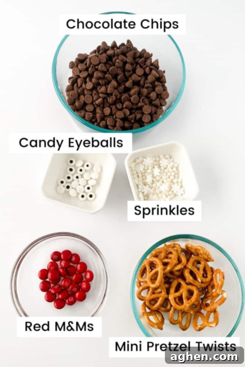 Bowls filled with key Reindeer Bark ingredients: chocolate chips, mini pretzel twists, red M&Ms, candy eyes, and paramount crystals for smooth melting.