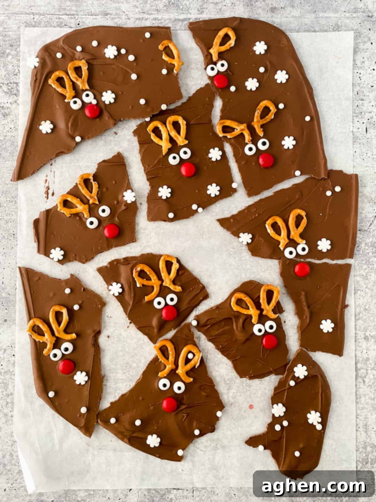Finished Reindeer Chocolate Christmas Bark, broken into charming pieces and displayed on parchment paper.
