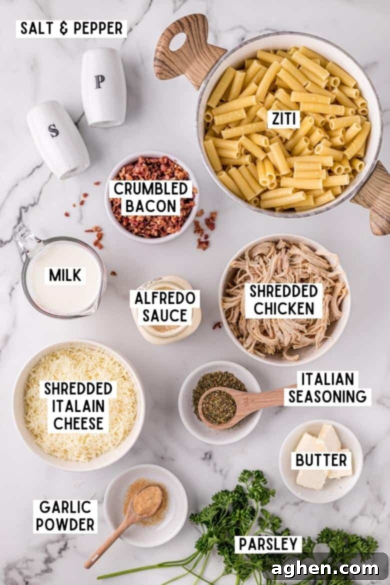 Ingredients on countertop: ziti, salt and pepper, crumbled bacon, shredded chicken, italian seasoning, shredded italian cheese, butter, alfredo sauce, milk, garlic powder and fresh parsley