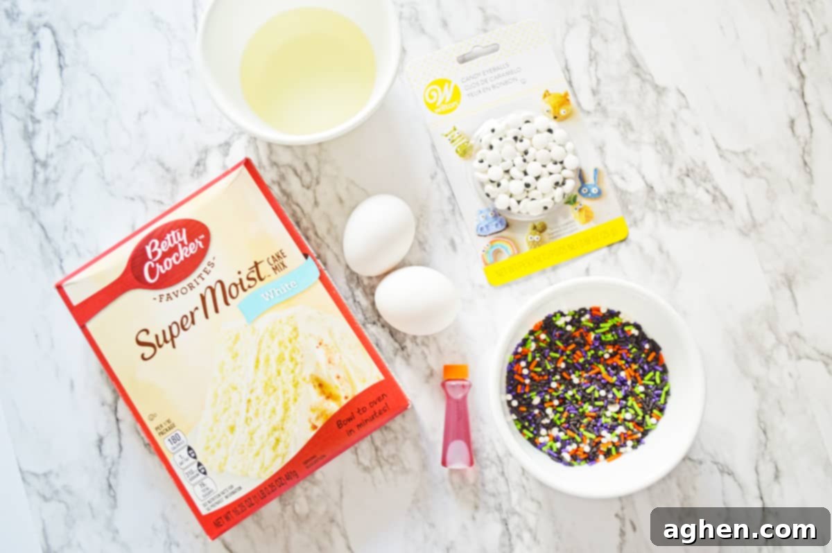 Box of white cake mix, oil, 2 eggs, candy eyes, Halloween sprinkles, and orange food coloring