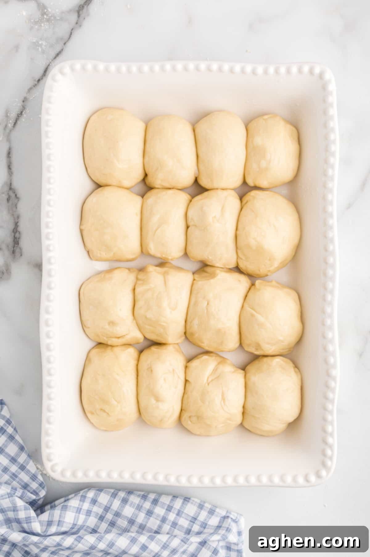 Unbaked potato roll buns in baking dish