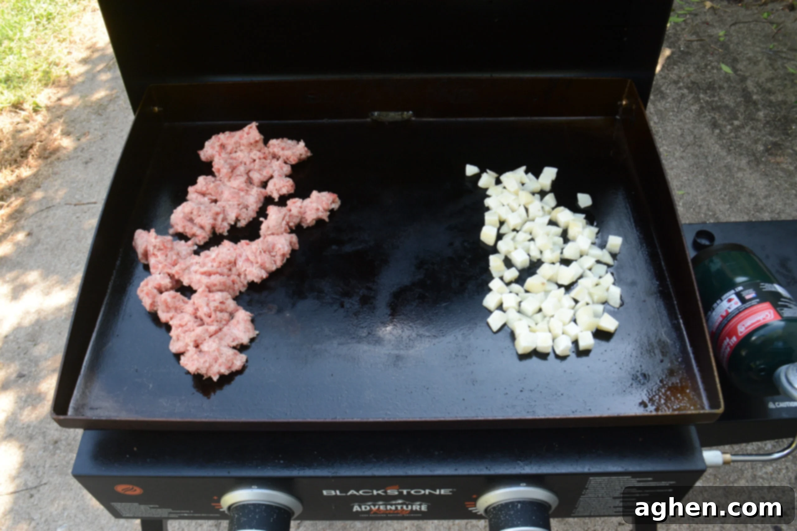 The sausage and potatoes are shown on the gridle. 