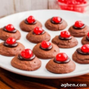 Chocolate cherry thumbprint cookies on white plate