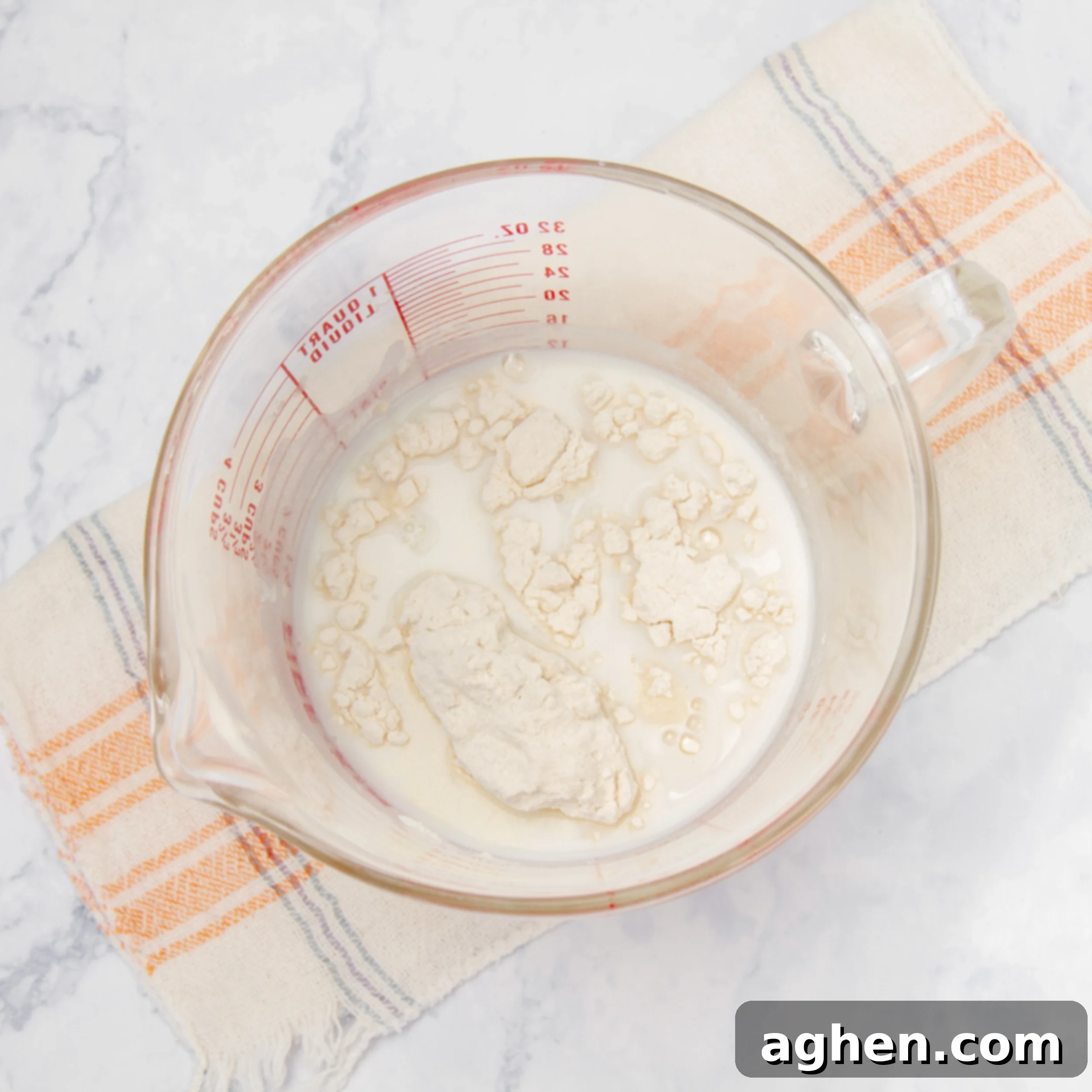 Mushroom soup mix, Greek yogurt, and skim milk being whisked together in a measuring cup to form the creamy sauce.