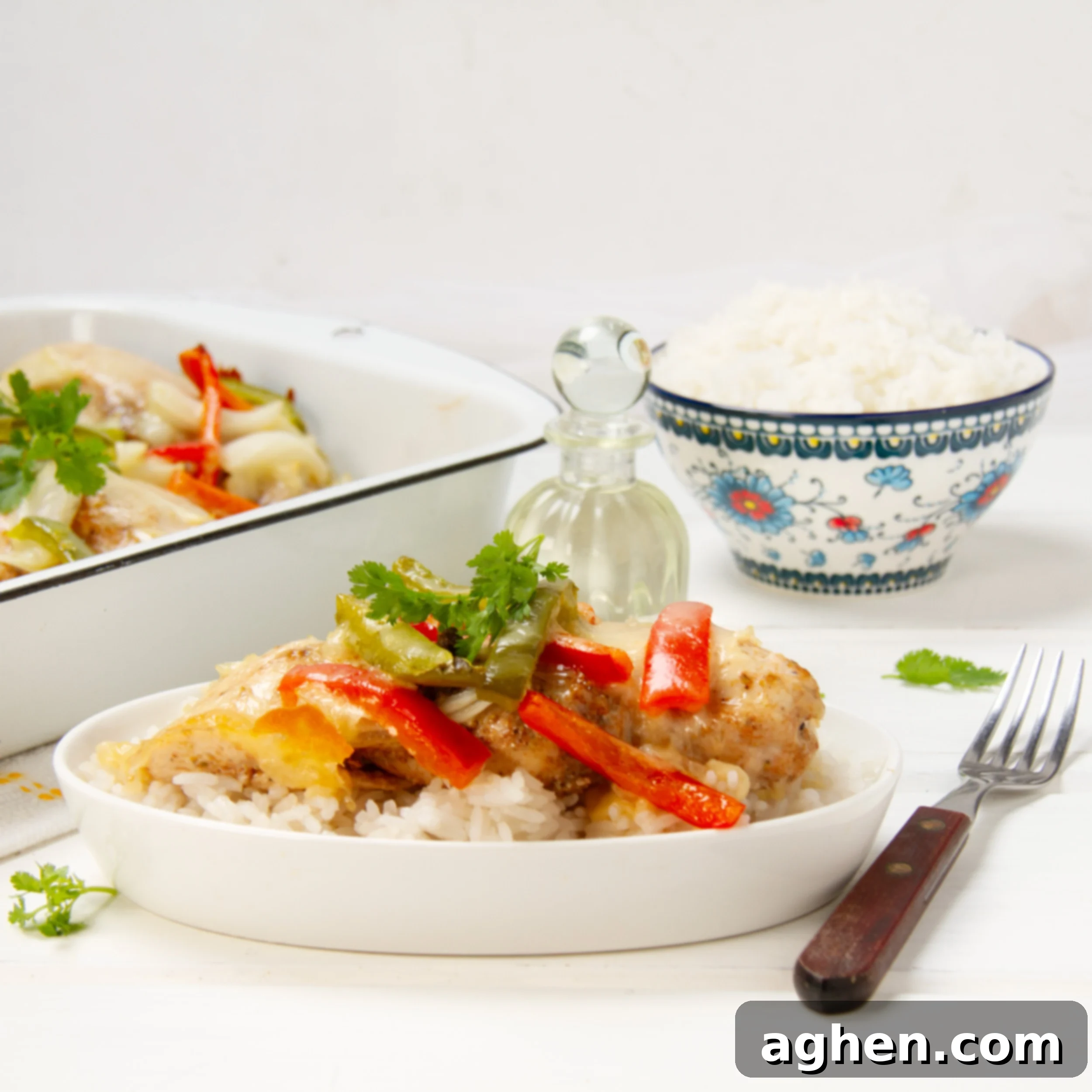 Cheesy Bell Pepper Chicken Casserole on a plate with a fork, showing melted cheese and tender chicken and vegetables.
