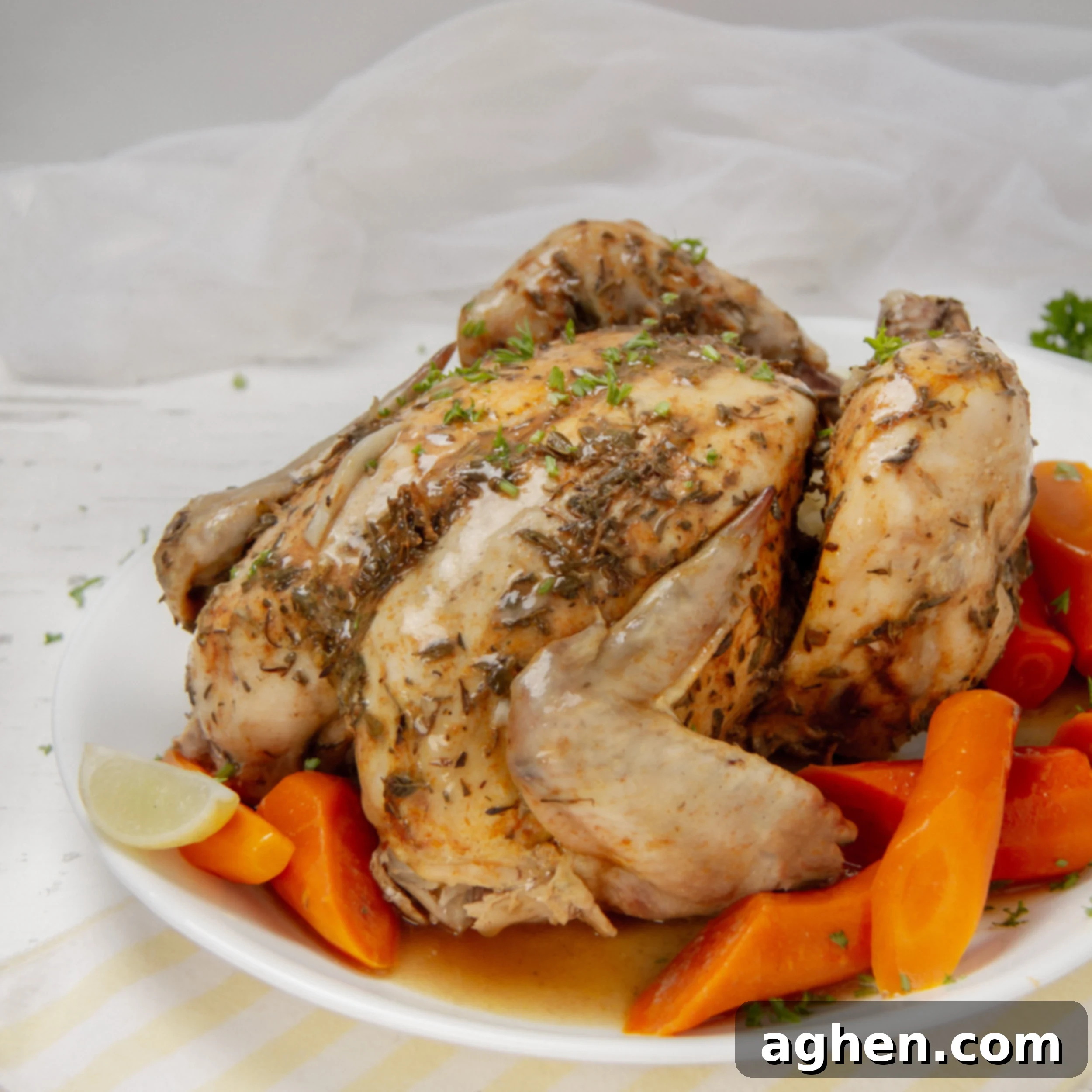 Easy Slow Cooker Whole Chicken 2 Juicy and succulent Slow Cooker Whole Chicken on a serving platter with carrots.