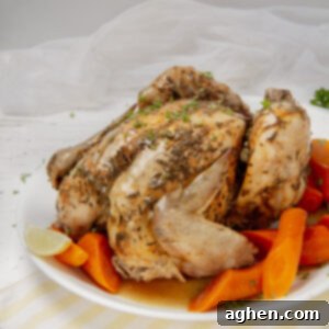Easy Slow Cooker Whole Chicken 7 Juicy and succulent Slow Cooker Whole Chicken on a serving platter with carrots.