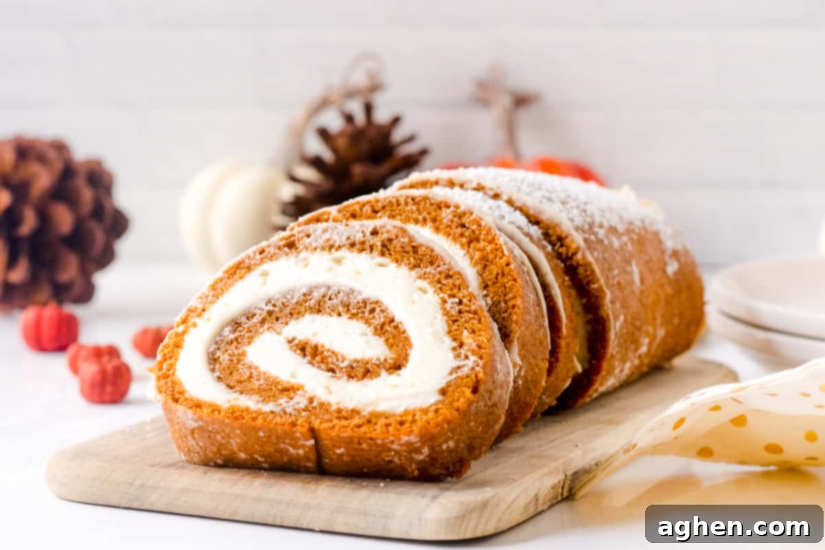 Autumn Pumpkin Cream Cheese Roll 13 Beautifully sliced pumpkin roll with a perfect swirl of cream cheese filling, dusted with powdered sugar, ready to serve.