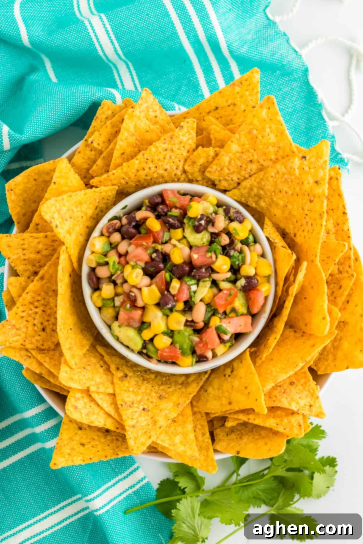 Cowboy Caviar Dip in a bowl surrounded by tortilla chips, ready for serving.