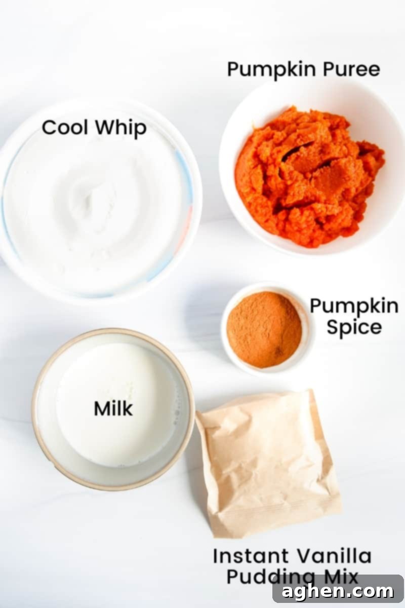 Ingredients on countertop: Cool Whip, pumpkin puree, instant vanilla pudding mix, milk, and pumpkin pie spice