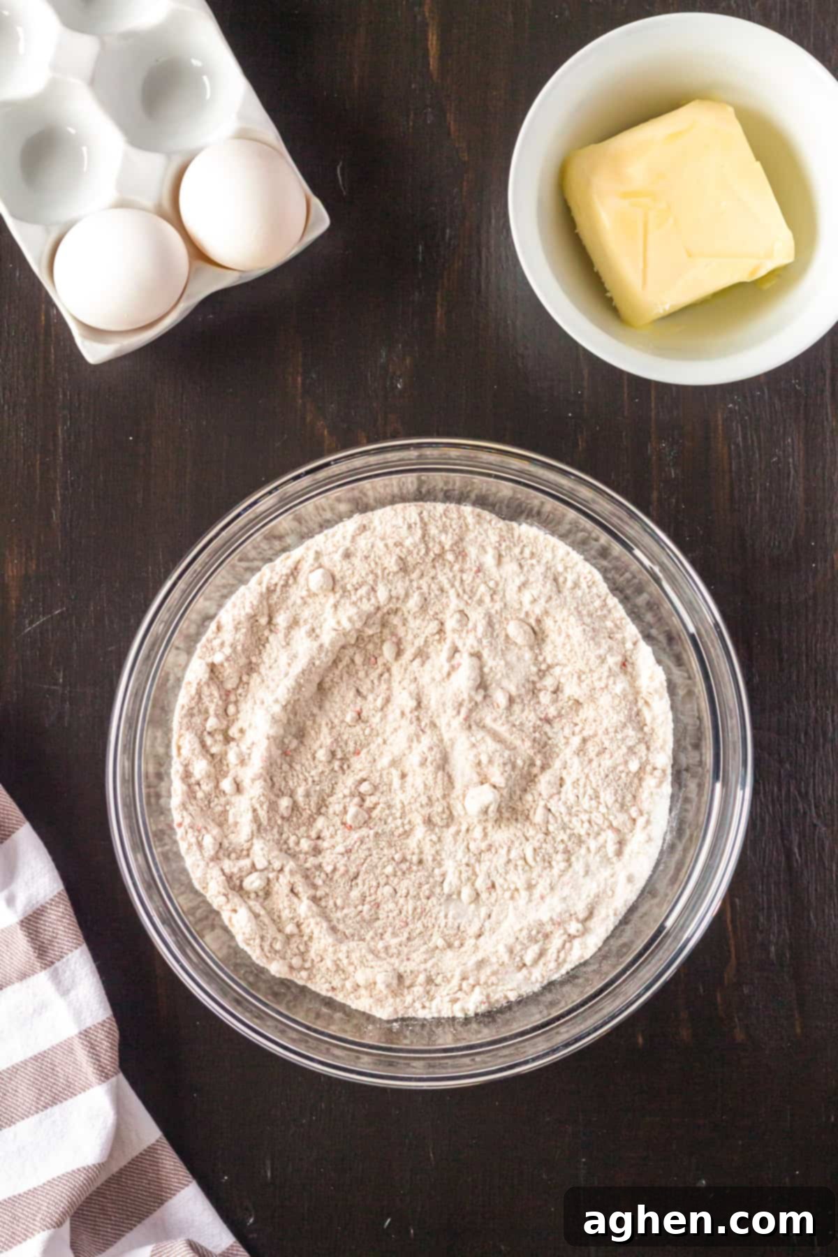 Dry ingredients for cake mix cookies in a large mixing bowl, including carrot cake mix, flour, and sugar, waiting to be combined.