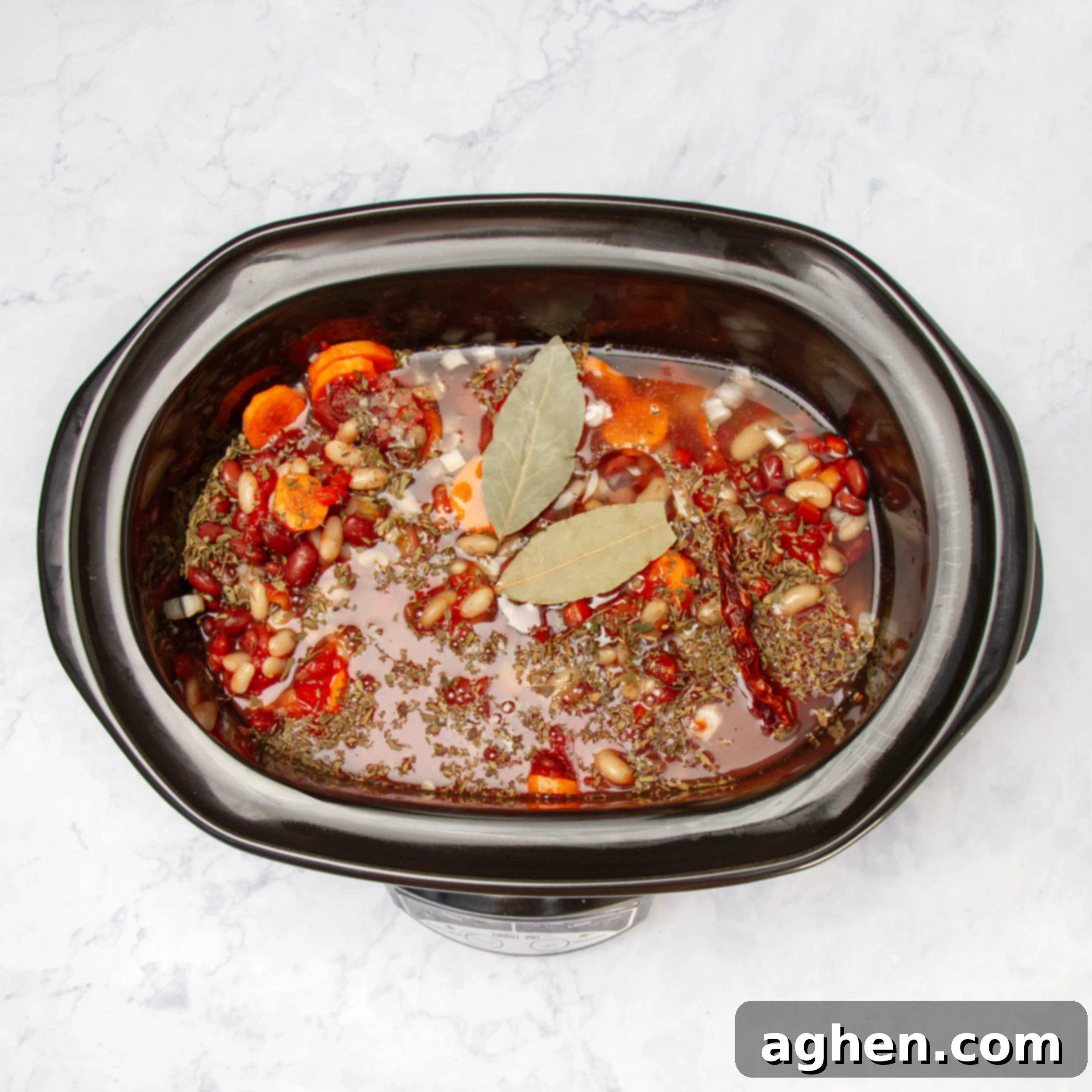 Faux Campfire Stew 6 Broth, tomatoes, spices, and bay leaf added into the Crock Pot basin.