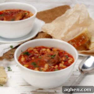 Faux Campfire Stew 8 Hearty and satisfying Campfire Stew in a bowl with a spoon on the side.