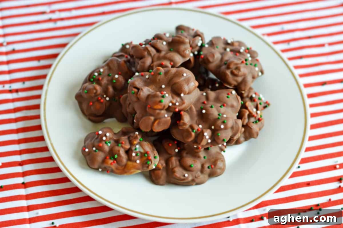 Plate of chocolate crockpot candy with peanuts on a red and white striped tablecloth