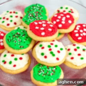 Tender Holiday Frosted Cookies 11 Platter of round frosted sugar cookies decorated with red, green, and white frosting and christmas sprinkles