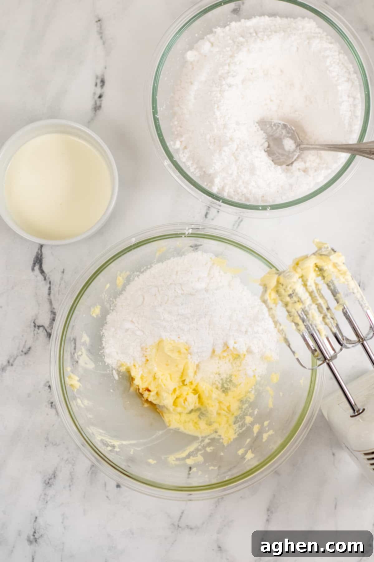 Tender Holiday Frosted Cookies 7 Large glass mixing bowl with creamed butter, powdered sugar, and hand mixer