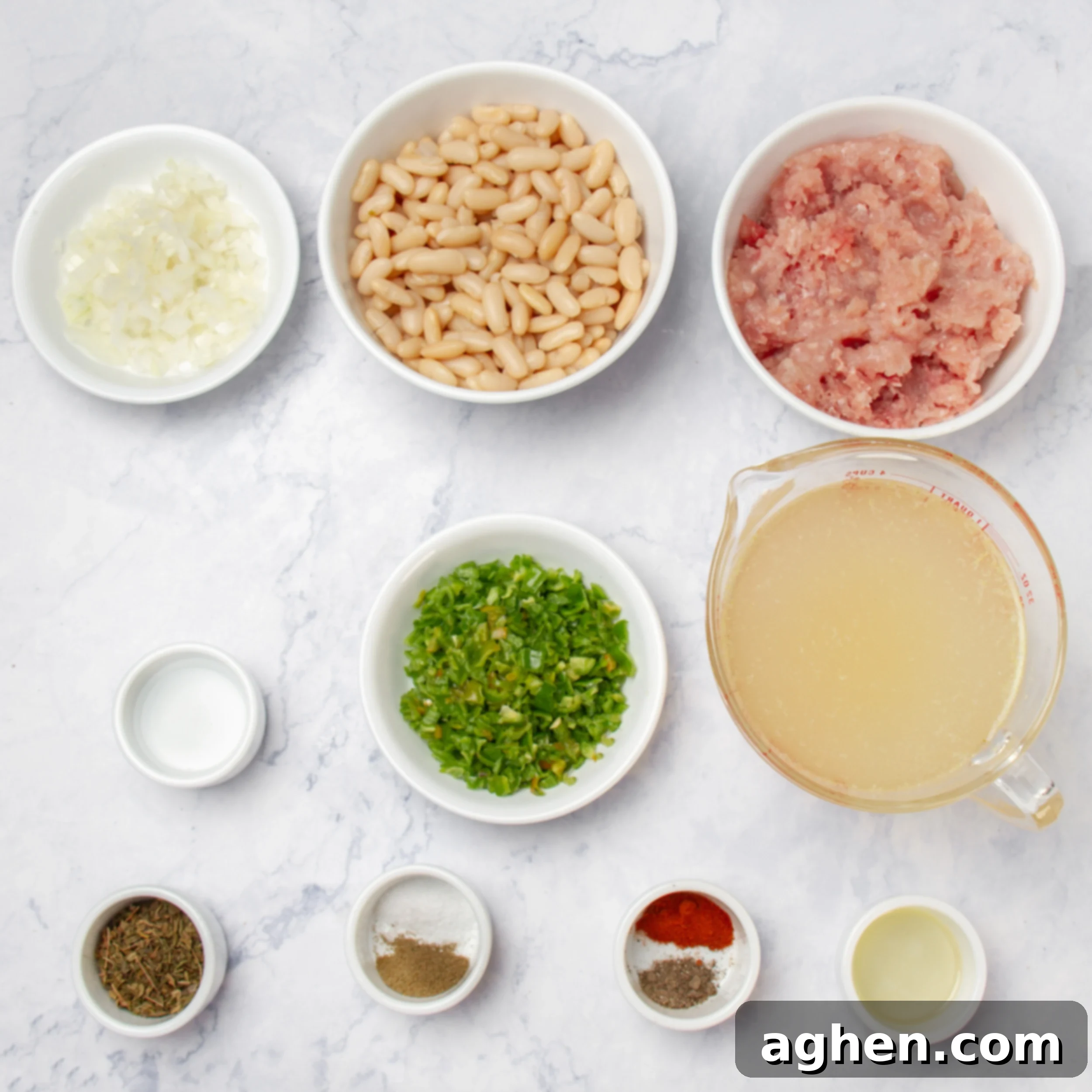 A colorful array of fresh ingredients for White Turkey Chili, neatly arranged in separate dishes on a rustic kitchen counter.