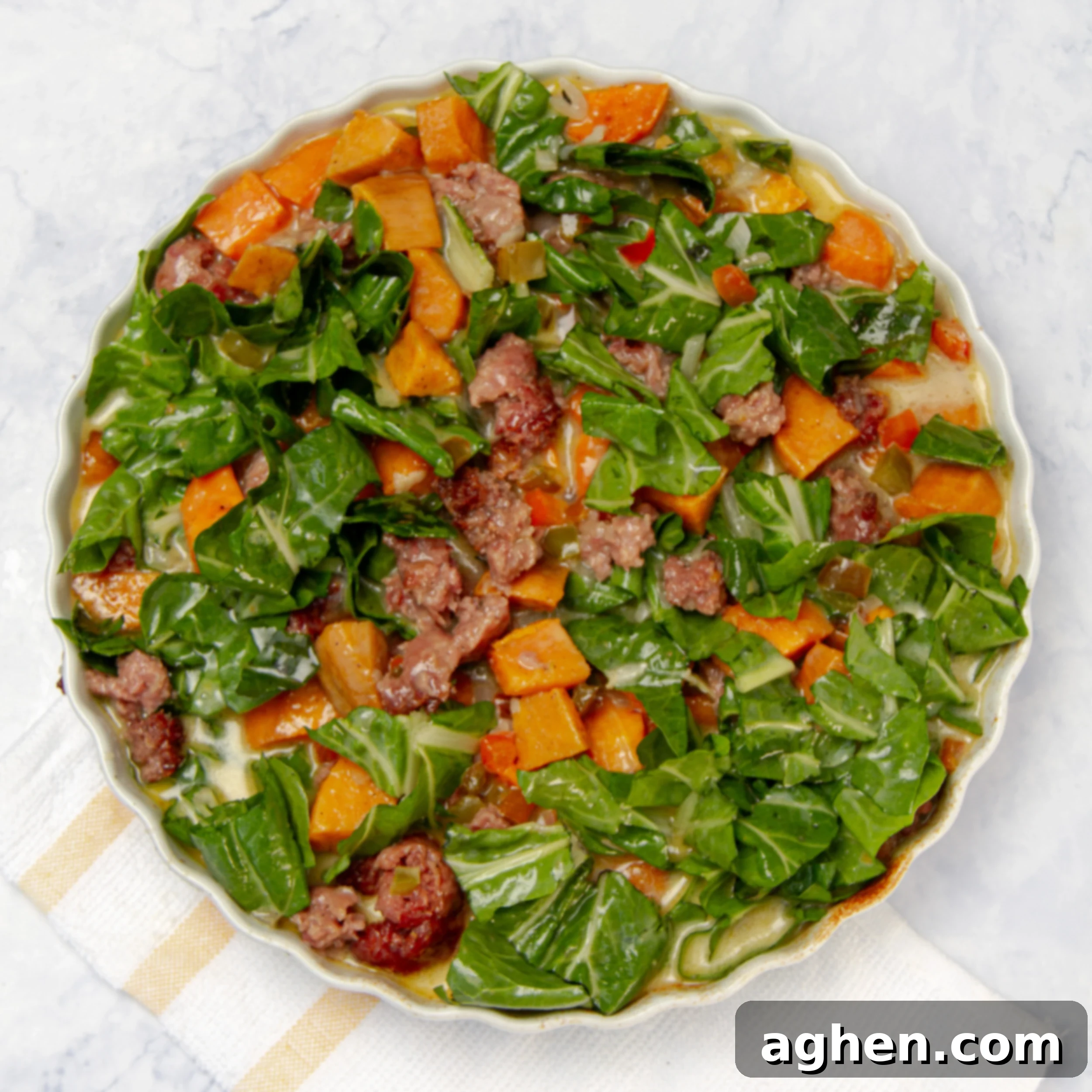 All casserole ingredients in a baking dish with whisked egg poured over. 