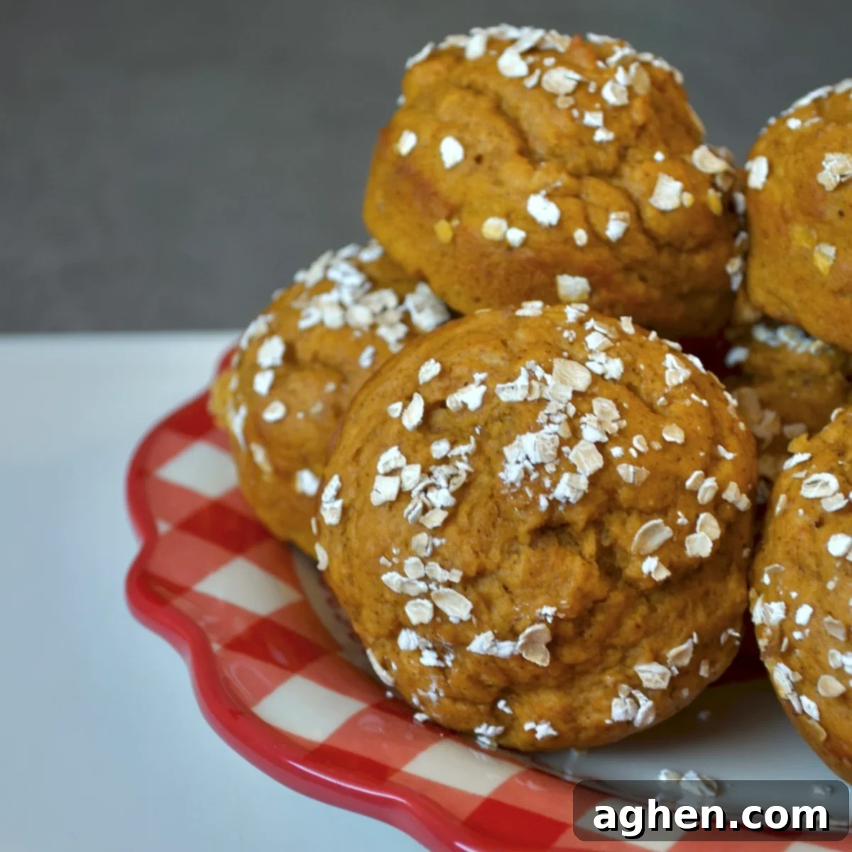 Pumpkin muffins on a plate, showcasing their moist and fluffy texture, ready to be enjoyed.