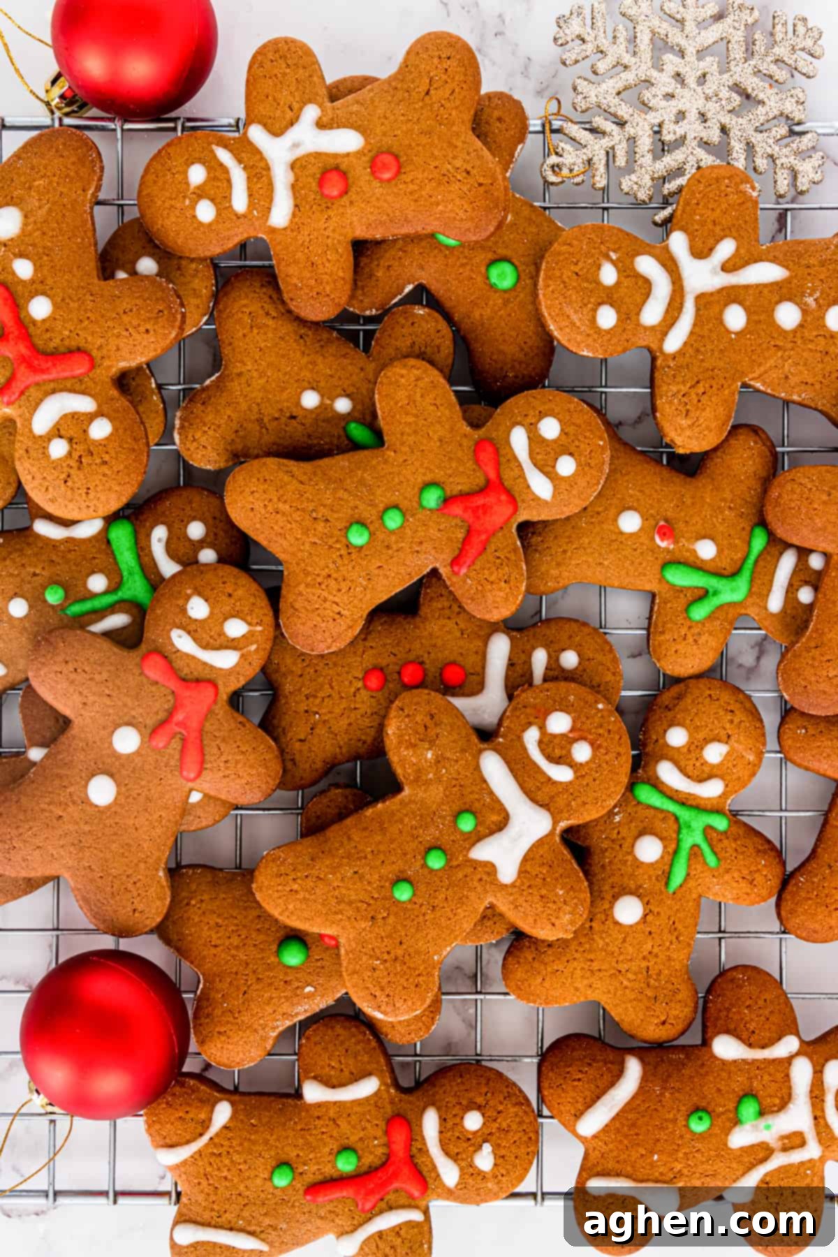 christmas gingerbread men cookies scattered and piled on top of cooling rack
