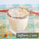 Christmas Cookie Cocktail with vodka in a christmas sprinkle rimmed glass