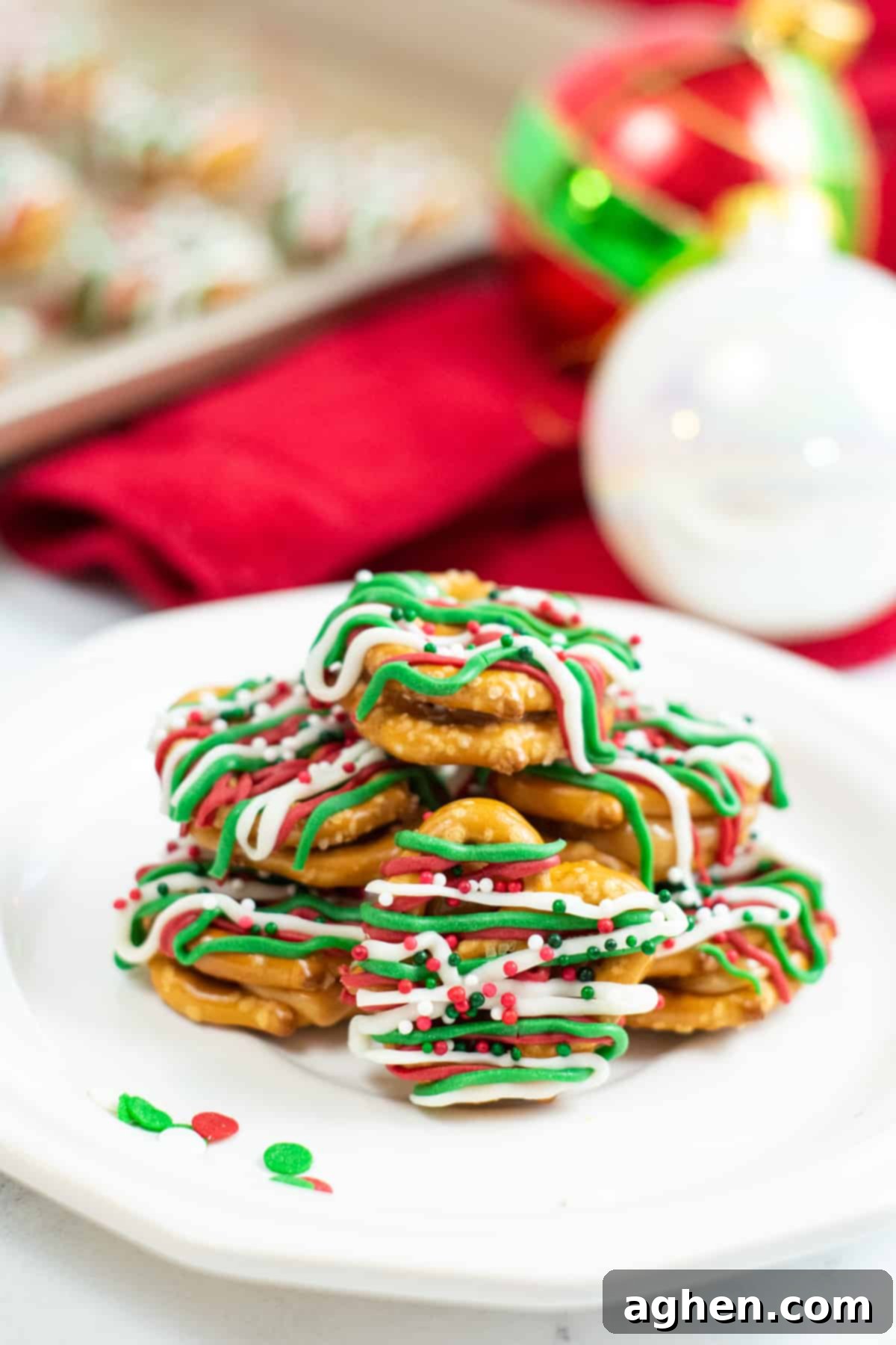 caramel pretzel bites drizzled with green, red, and white chocolate and topped with holiday sprinkles